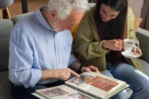 An elderly man shows photos with happy memories of his life.